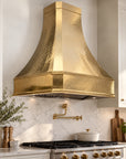 Classic custom brass range hood cover in unlacquered brass