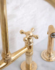 Seven bridge faucet in unlacquered solid brass