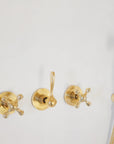 Santorini style curved arm shower in natural unlacquered brass