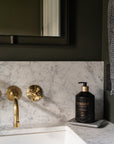 Unlacquered brass wall mount bathroom faucet that develops a natural patina