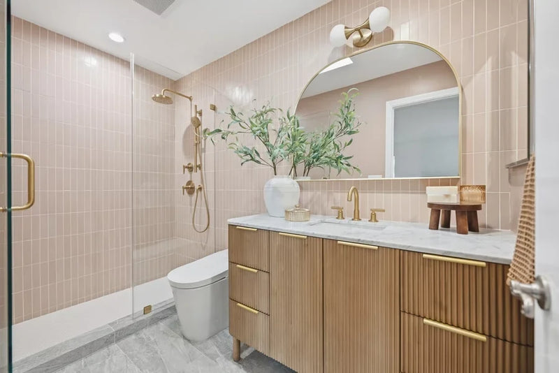 Interior shot of a luxury contemporary bathroom featuring brass bathroom fixtures