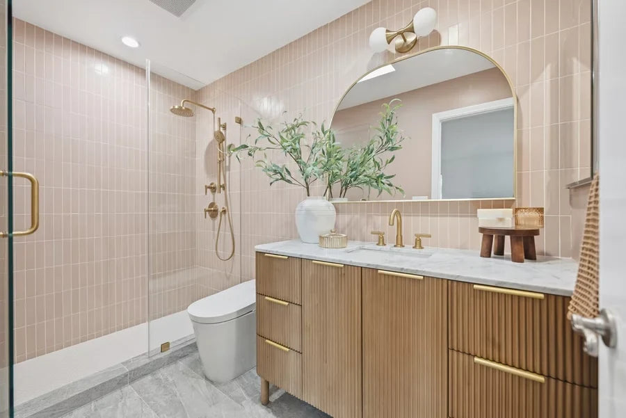 Interior shot of a luxury contemporary bathroom featuring brass bathroom fixtures