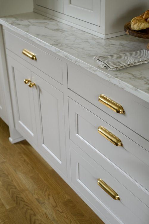 Unlacquered brass cabinet knobs and pulls by Brasslik