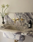 Unlacquered brass wall-mounted faucet handcrafted by Brasslik