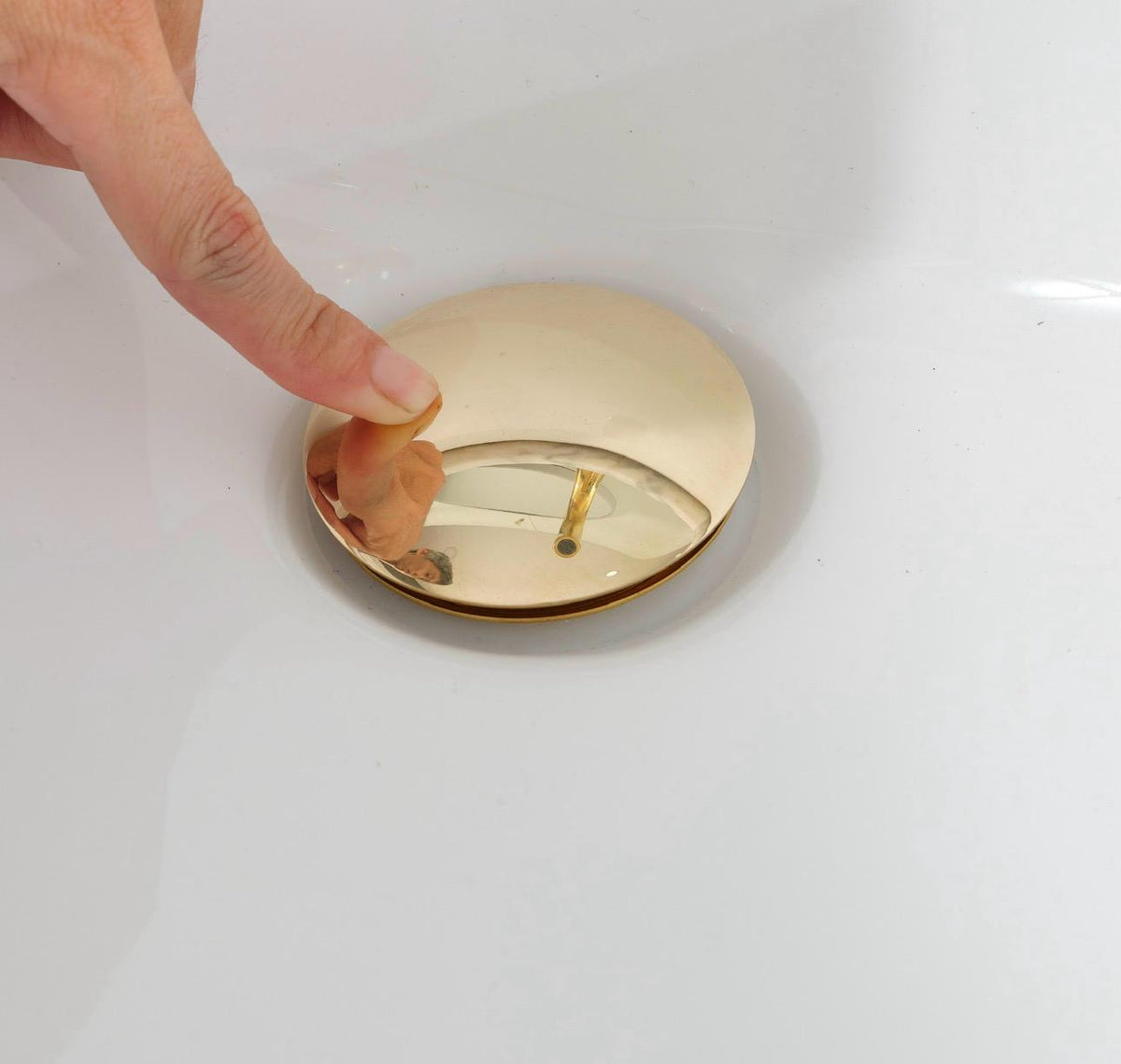 Finger Pressing on Brass Sink Drain