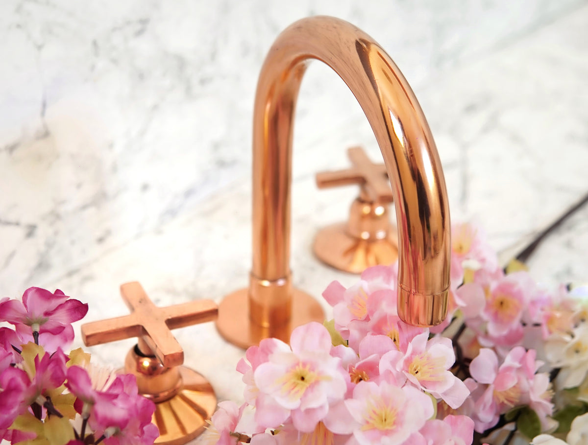 Brass bathroom faucet with copper finish, deck mount design