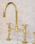 Curved-leg unlacquered brass bridge kitchen faucet, handcrafted