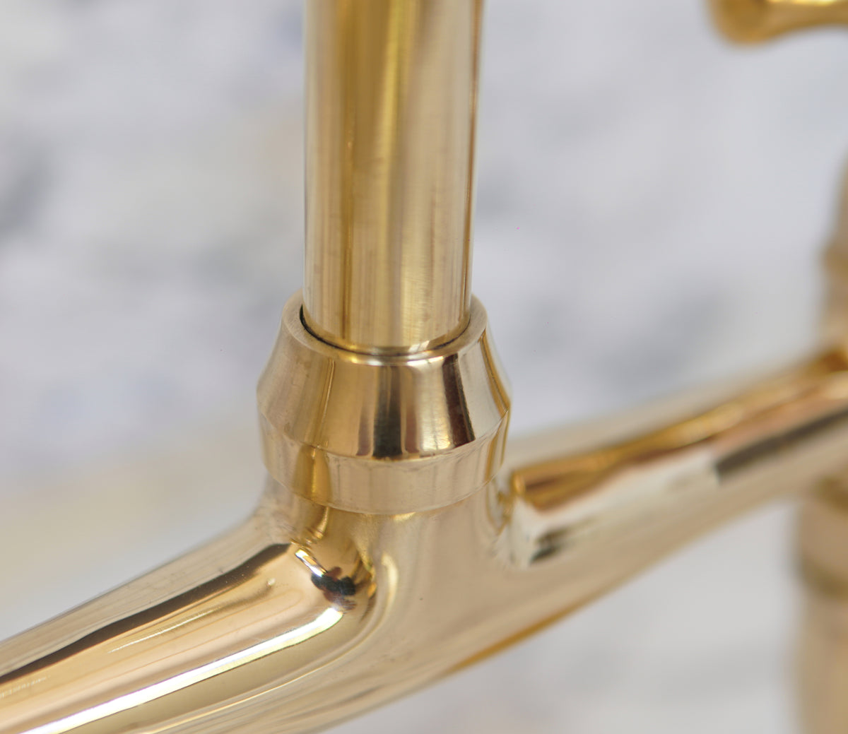 Handcrafted curved leg bridge faucet in brass