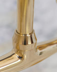 Handcrafted curved leg bridge faucet in brass