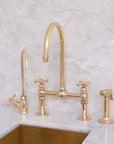 Traditional Dusty unlacquered brass bridge faucet for kitchens