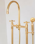 Unlacquered brass freestanding tub faucet that develops a natural patina