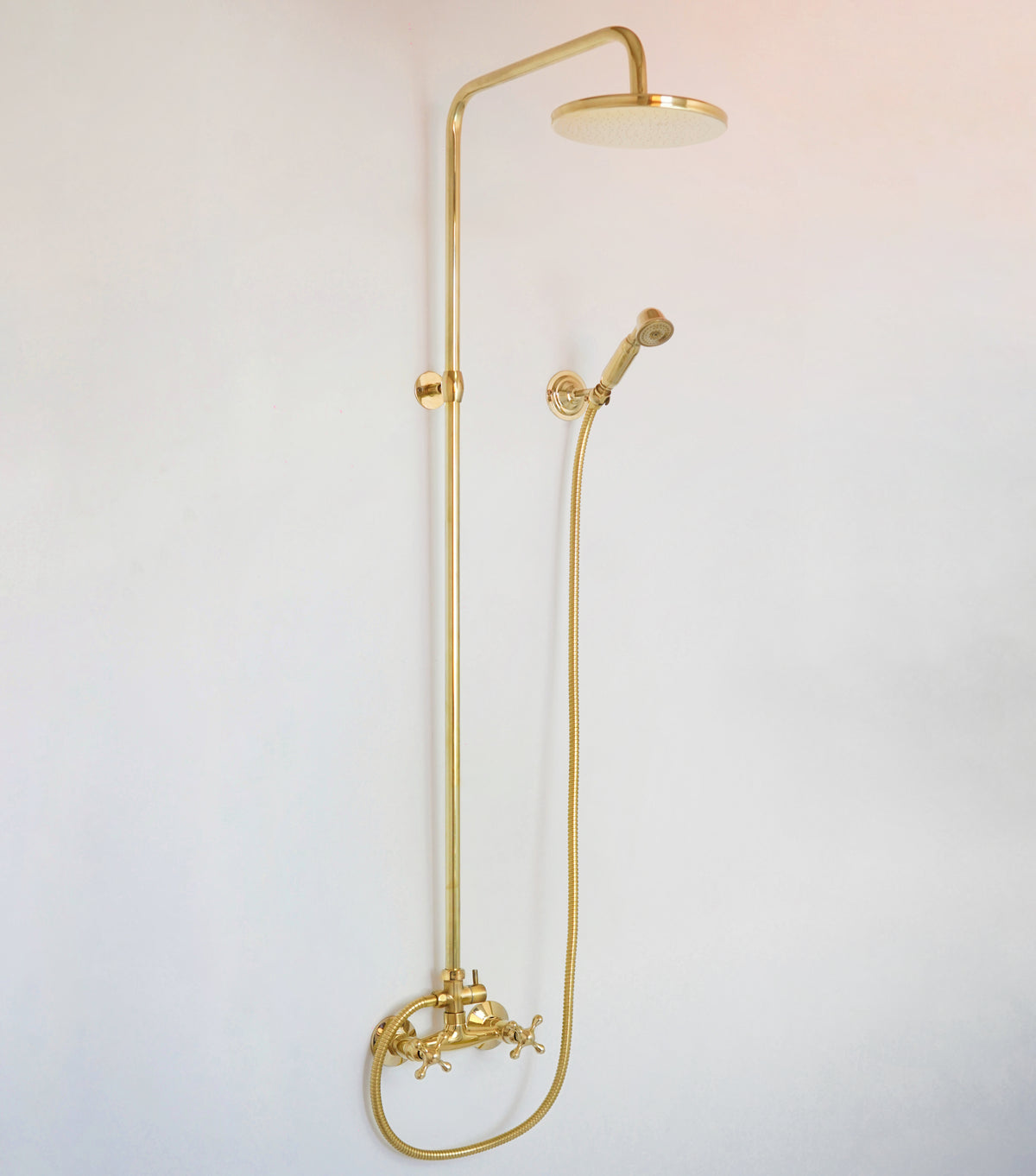 High pressure exposed pipe shower system in solid unlacquered brass