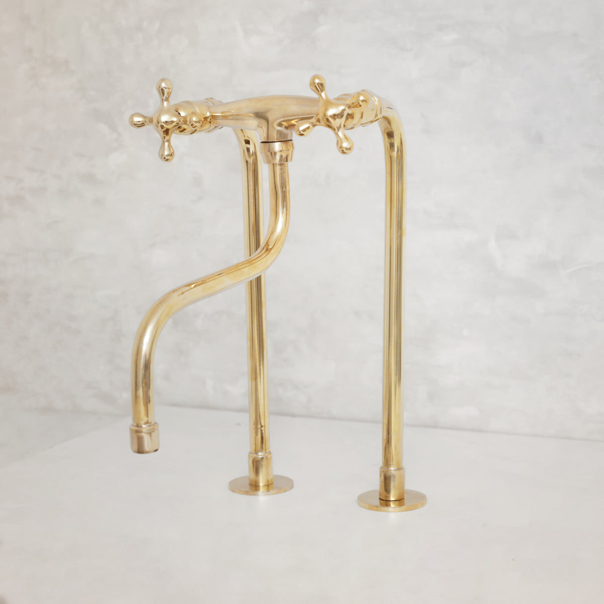 Unlacquered brass kitchen faucet with long legs and elephant trunk spout