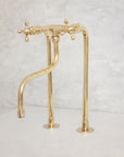 Unlacquered brass kitchen faucet with long legs and elephant trunk spout