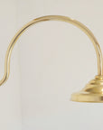 Wall-mounted Santorini brass shower with curved arm