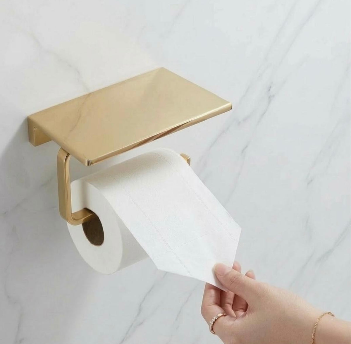 Brass Toliet Paper Holder with Shelf Mounted on Marble Wall