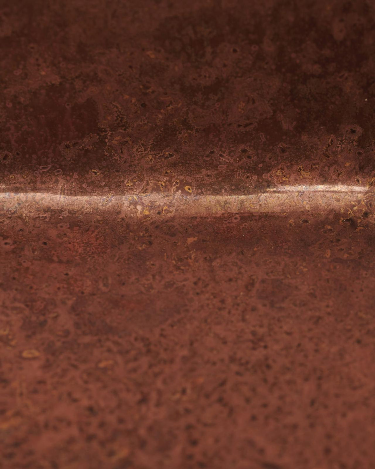 Unlacquered copper bar sink with natural patina