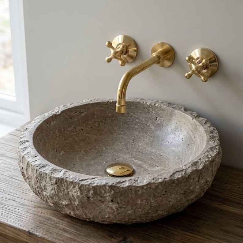 Wall-mounted bathroom faucet in unlacquered brass