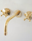 Handcrafted unlacquered brass wall-mount faucet
